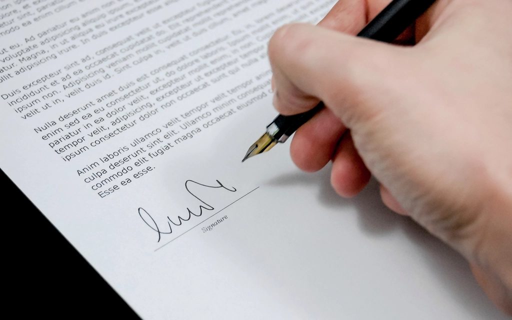 Main signant un contrat au stylo plume